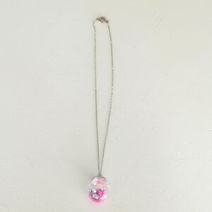 Silver Necklace with Pink and silver mini jingle bells in a glass globe Pendant